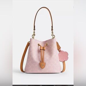 Coach Powder Pink Rowan Bucket Bag In Signature Canvas With Charms